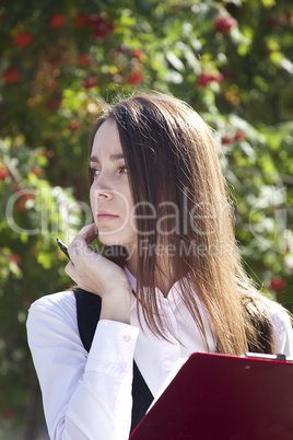 Young woman work with pen in park