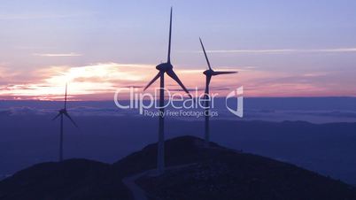 Wind turbine generator in the mountains at sunset