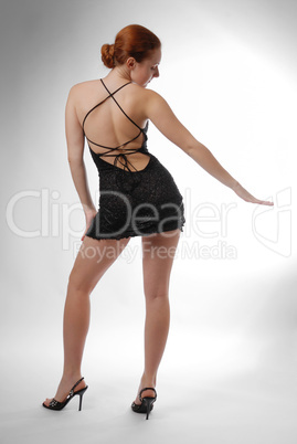 Model dancing in short dress, rear view