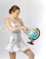Snowgirl with terrestrial globe on light background