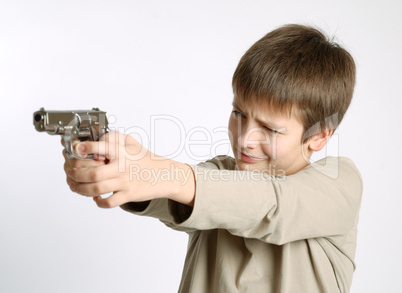 Child with gun on light background