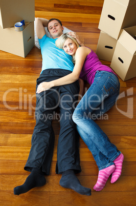 Couple lying on the floor. Moving house