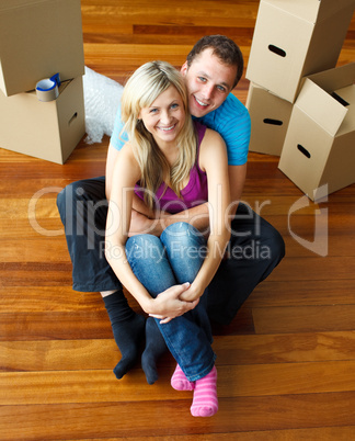 High angle of a couple sitting on floor. Moving house