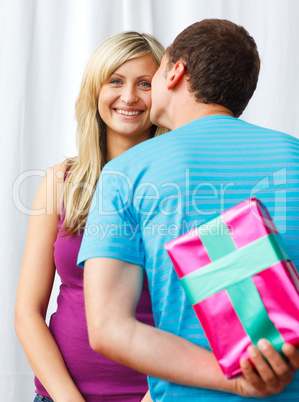 Boyfriend giving a present and a kiss to his girlfriend