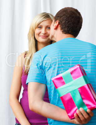 Man giving a present to a woman and a kiss