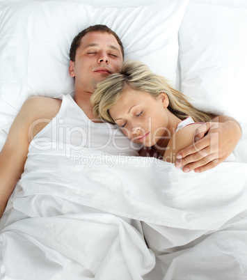 Junges Paar schläft aneinandergekuschelt