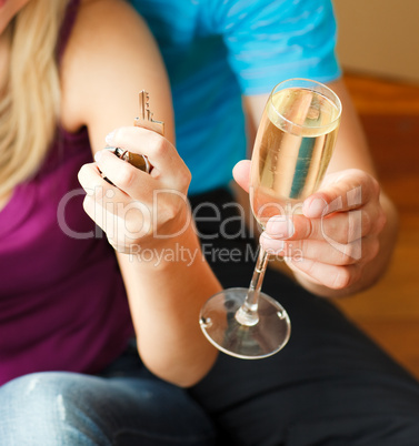 Close-up of a key and a glass of champagne. Concept of buying ho