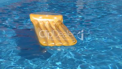 Air bed floating on a swimming pool