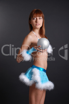 Fairy with snowball on dark background, side view