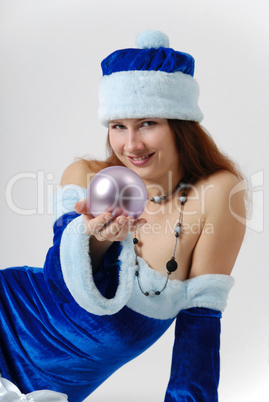 Female Santa with christmas ball on light background