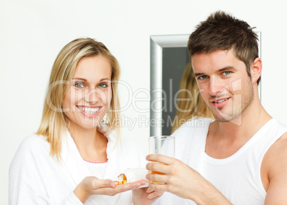 couple in bathroom with pills