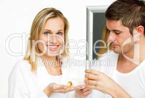 couple in bathroom with pills