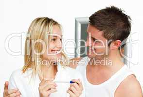 couple holding a pregnancy test