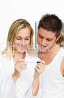 couple examining a pregnancy test