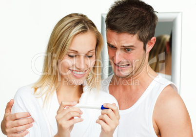 couple examining a pregnancy test