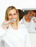 couple cleaning their teeth