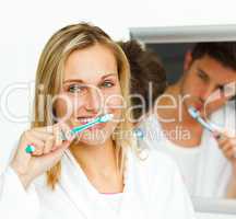 couple cleaning their teeth