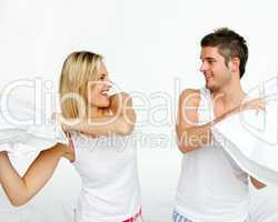 couple fighting with pillows