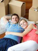 couple lying on floor with a lot of boxes