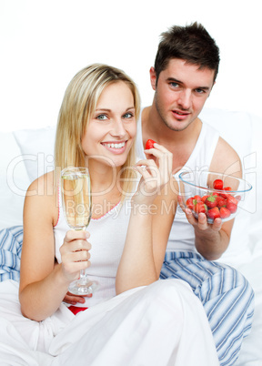 Couple eating in bed