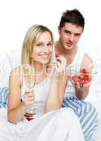 Couple eating in bed