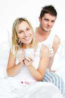 Couple having breakfast in bed