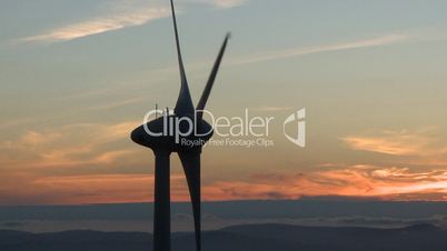 Wind turbine in the mountains at sunset