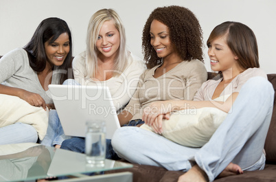 Four Young Women Friends Having Fun Using A Laptop Computer