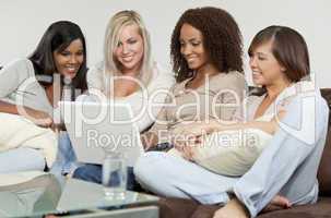 Four Young Women Friends Having Fun Using A Laptop Computer