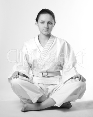 Girl in white kimono sitting traditionally