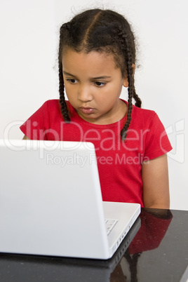Little Girl Using A Laptop Computer