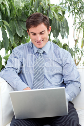 Businessman using a laptop on couch