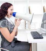 Businesswoman with a megaphone