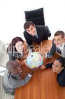 smiling team holding a globe