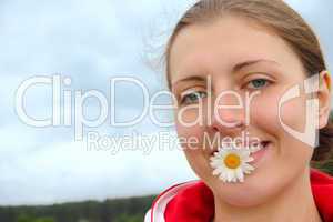 The girl with chamomile in teeth
