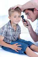 Doctor examining a patient' s ears with a otoscope