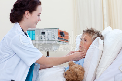 Female doctor examining child throat