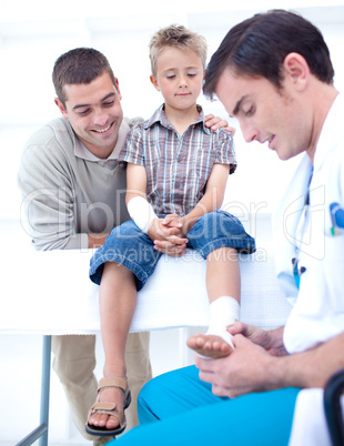 Doctor bandaging a child's foot