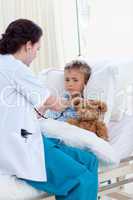 Female doctor listening to a child chest with stethoscope