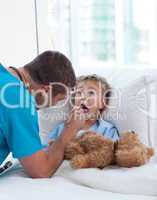 Male doctor examining child throat
