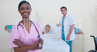 Smiling Indian nurse with doctor and patient