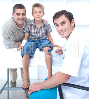 Doctor checking a boy reflexes