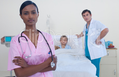 Serious attractive nurse with doctor and patient