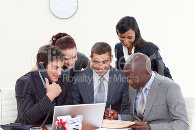 Business people in a meeting  using a telephone and a laptop