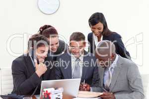 Business people in a meeting  using a telephone and a laptop