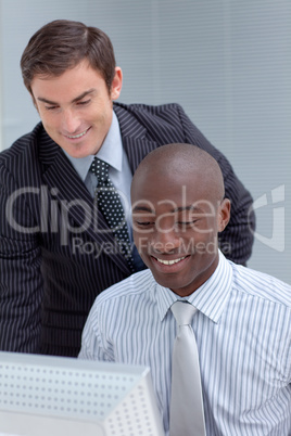 Businessmen using a laptop together