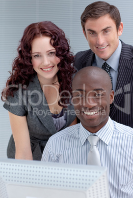 Businessmen and businesswoman with a computer
