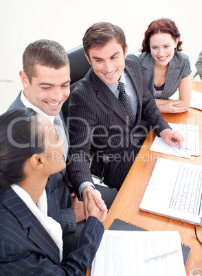 Business team in a meeting shaking hands