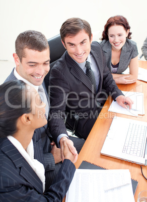 Businessman and businesswoman in a meeting shaking hands