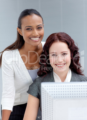 Businesswomen working together in office and smiling